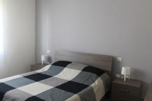 Postel nebo postele na pokoji v ubytování Bilocale Vega-Intero appartamento ad uso esclusivo by Appartamenti Petrucci by Appartamenti Petrucci