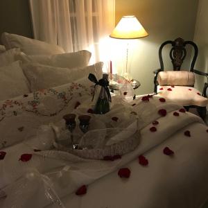 a bed with a bunch of hearts on it at Sweet Dreams Bed and Breakfast Cutchogue in Cutchogue