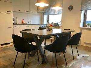 a kitchen with a table and chairs in it at City Apartment in Nuremberg