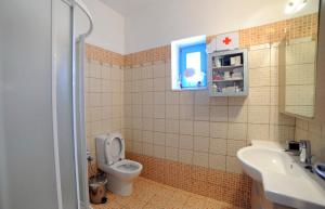 a bathroom with a toilet and a sink and a window at Villa Busho in Naousa +77 photos