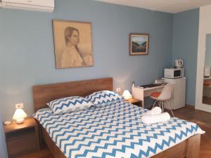 a bedroom with a bed and a desk in it at Tajc Rooms in Split