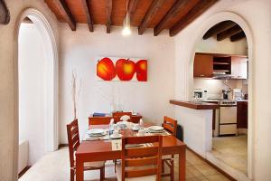 a kitchen and dining room with a table and chairs at Villas Casa Divina At San Felipe Church Area in Oaxaca City
