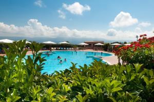 a large swimming pool with people in the water at Popilia Country Resort in Pizzo