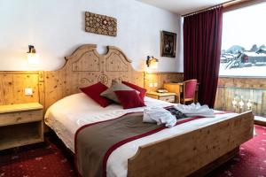 Postel nebo postele na pokoji v ubytování Hôtel Le Relais Alpin