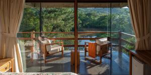 a room with a balcony with a view of a river at Fazenda Capoava in Itu