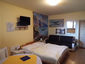 a bedroom with two beds and a tv on the wall at Dom Gościnny Barbara in Polańczyk