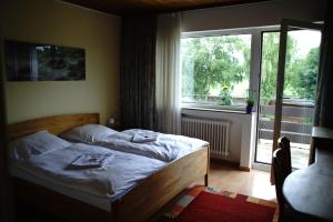 a bedroom with a bed and a large window at St. Jobser Hof in Würselen