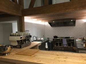 a kitchen with a wooden counter top in a kitchen at Die Grüne Bettlad Boutique-Hotel in Bühl +24 photos