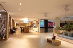 a lobby of a store with a couch and a table at Blu Hotel by Tamaca in Santa Marta