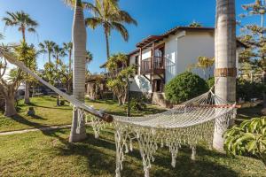a hammock in front of a house at Finca Santa Maria in Callao Salvaje