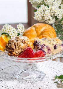 a glass plate with a cake and strawberries on a table at Washington House Inn in Cedarburg