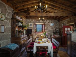 a dining room with a table in a stone house at Casa Das Videiras in Soajo