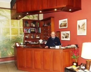a man sitting at a bar in a room at Hostal Gemina in Lima