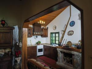 a kitchen with a stove and a fireplace at Casa de Pereiró in Soajo
