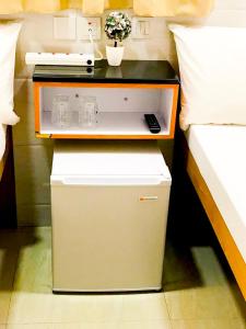 a bed room with a nightstand next to a bed at Holiday Guest House in Hong Kong