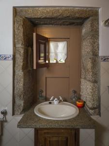 baño con lavabo y ventana en Casa Das Videiras, en Soajo