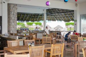 a restaurant with wooden tables and chairs and people in the background at BSEA Cancun Plaza Hotel in Cancún