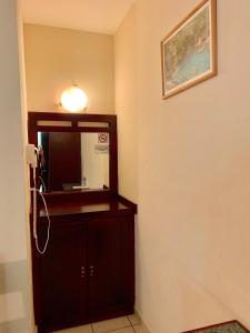 a small room with a television on a wall at Hotel Cosmos in Tamasopo