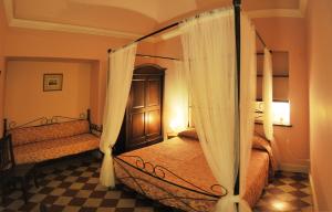 a bedroom with two beds with curtains at Al Duomo Inn in Catania