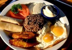 a plate of breakfast food with eggs and bread at Hotel Wagelia Espino Blanco in Turrialba +15 photos