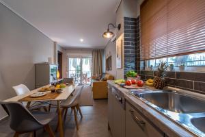 a kitchen with a sink and a table with chairs at Las Palmas in Kavála