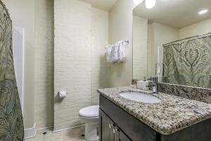 a bathroom with a sink and a toilet at Modern Condos near French Quarter & Bourbon Street in New Orleans +22 photos
