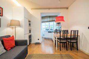 a living room with a couch and a dining room table at Casa da Praceta in Lisbon