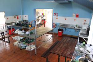 a kitchen with blue walls and a counter in a room at Red Rock Hostel in Alice Springs +17 photos