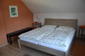 a bedroom with a bed and a bench in it at Ferienwohnung Quaiser in Cuxhaven