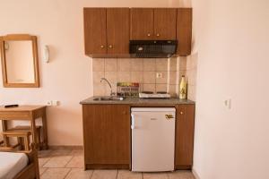 A kitchen or kitchenette at Atira Apartment Hotel