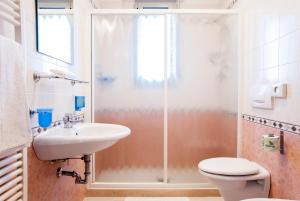 a bathroom with a toilet and a sink and a shower at Residence Cigno in Rimini +33 photos