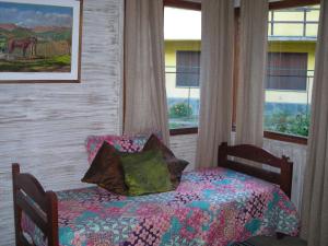 a bedroom with a bed and a window at Cabaña turística Weber in San Martín de los Andes