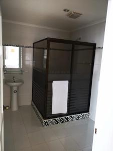 a bathroom with a shower with a toilet and a sink at Hotel y Restaurante Costa del Sol in Mata de Limón