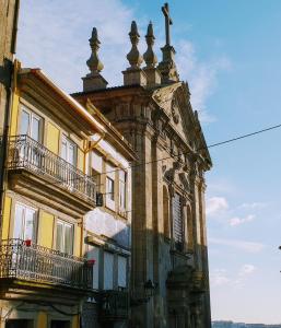 a building with a cross on the top of it at Merc Porto Vitoria's Place in Porto