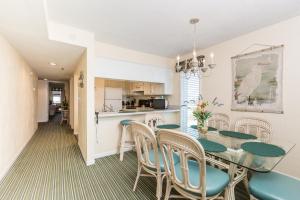 a dining room and kitchen with a table and chairs at Windy Shores II in Myrtle Beach