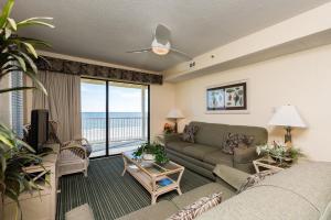 a living room with a couch and a view of the ocean at Windy Shores II in Myrtle Beach