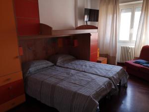 A bed or beds in a room at Checchi House