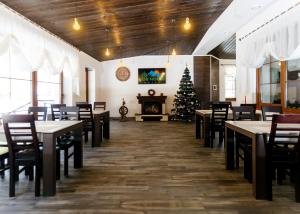 a dining room with tables and a christmas tree at GORHouse Hotel in Yaremche