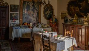 une salle à manger avec une table et un tableau mural dans l'établissement Antica Dimora Conti Custoza, à Roverbella