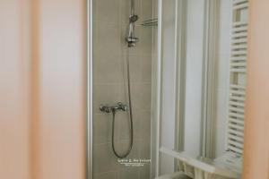 a shower in a bathroom with a glass door at Apartamenty Bystrzycka - Bliżej Zdroju in Polanica-Zdrój +43 photos