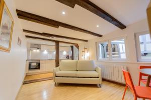 a living room with a white couch and a table at Cosy & quiet flat in historical lively center of Strasbourg in Strasbourg