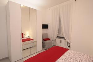 a bedroom with two beds and a mirror at A due passi dalla LANTERNA in Genoa