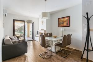 a dining room with a table and chairs at Keystone Apartments in Donji Morinj