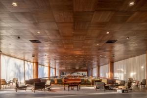 a lobby with chairs and tables and a piano at B Hotel Brasilia in Brasilia
