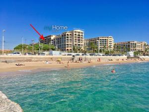 a group of people in the water at a beach at MyHome Riviera - Cannes Sea View Apartment Rentals in Cannes