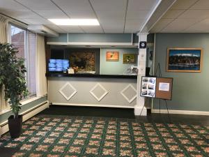 a waiting area of a hospital with a reception counter at Baxter Park Inn in Millinocket