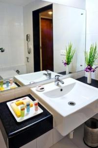 a bathroom with a sink and a mirror at Hotel Southern Grand in Vijayawāda