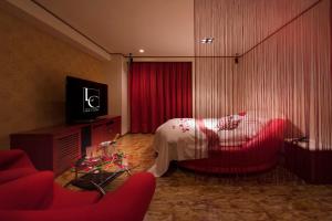 a hotel room with a bed and a red chair at Hotel LUNE CLAIRE (Adult Only) in Chikuma