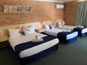 Postel nebo postele na pokoji v ubytování Branxton House Motel