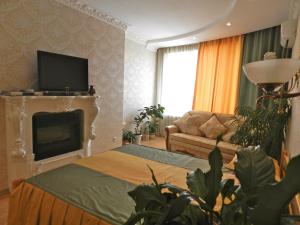 a living room with a fireplace and a television at Ap-Rent Osokorky Apartments in Kyiv